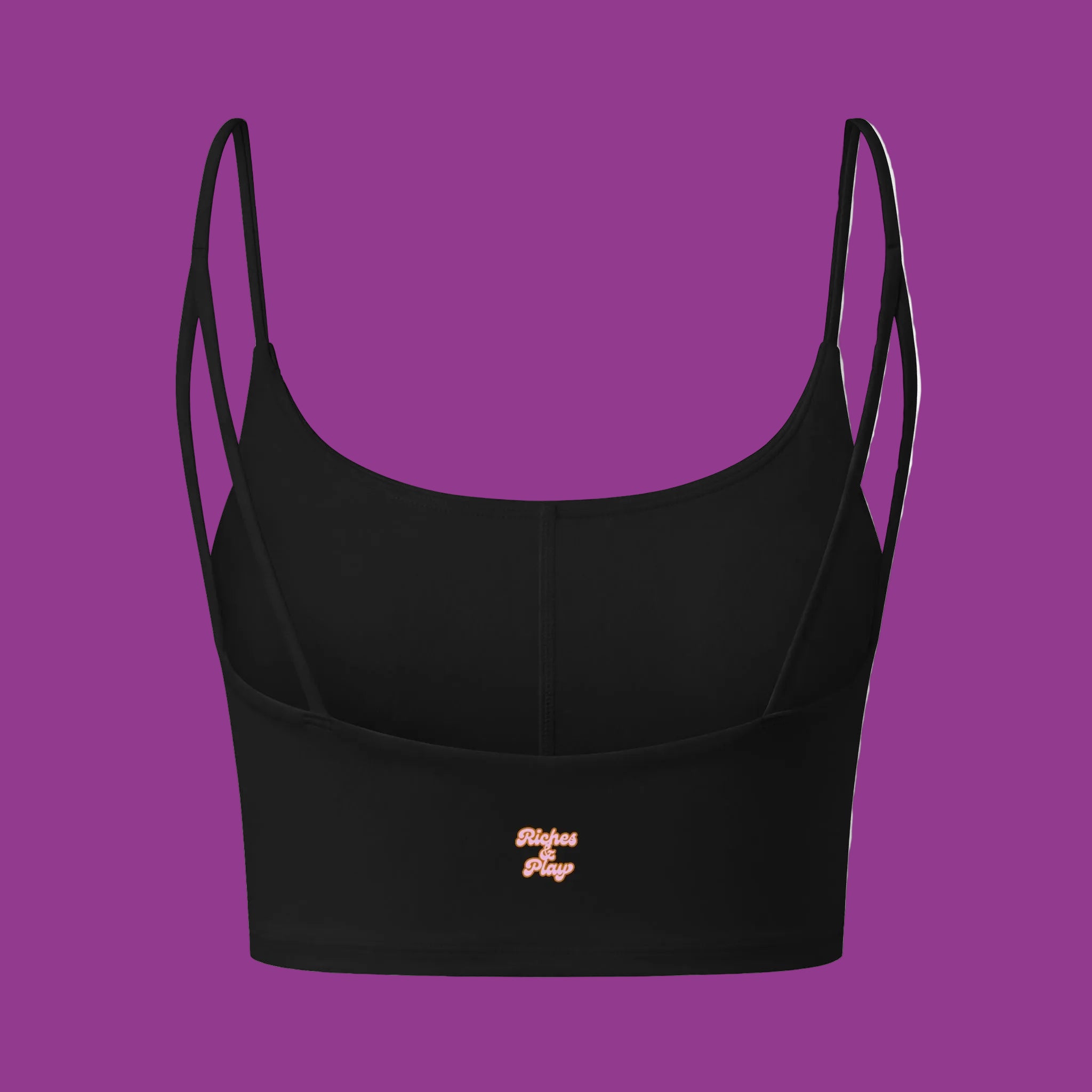 Black crop top with thin straps on a purple background