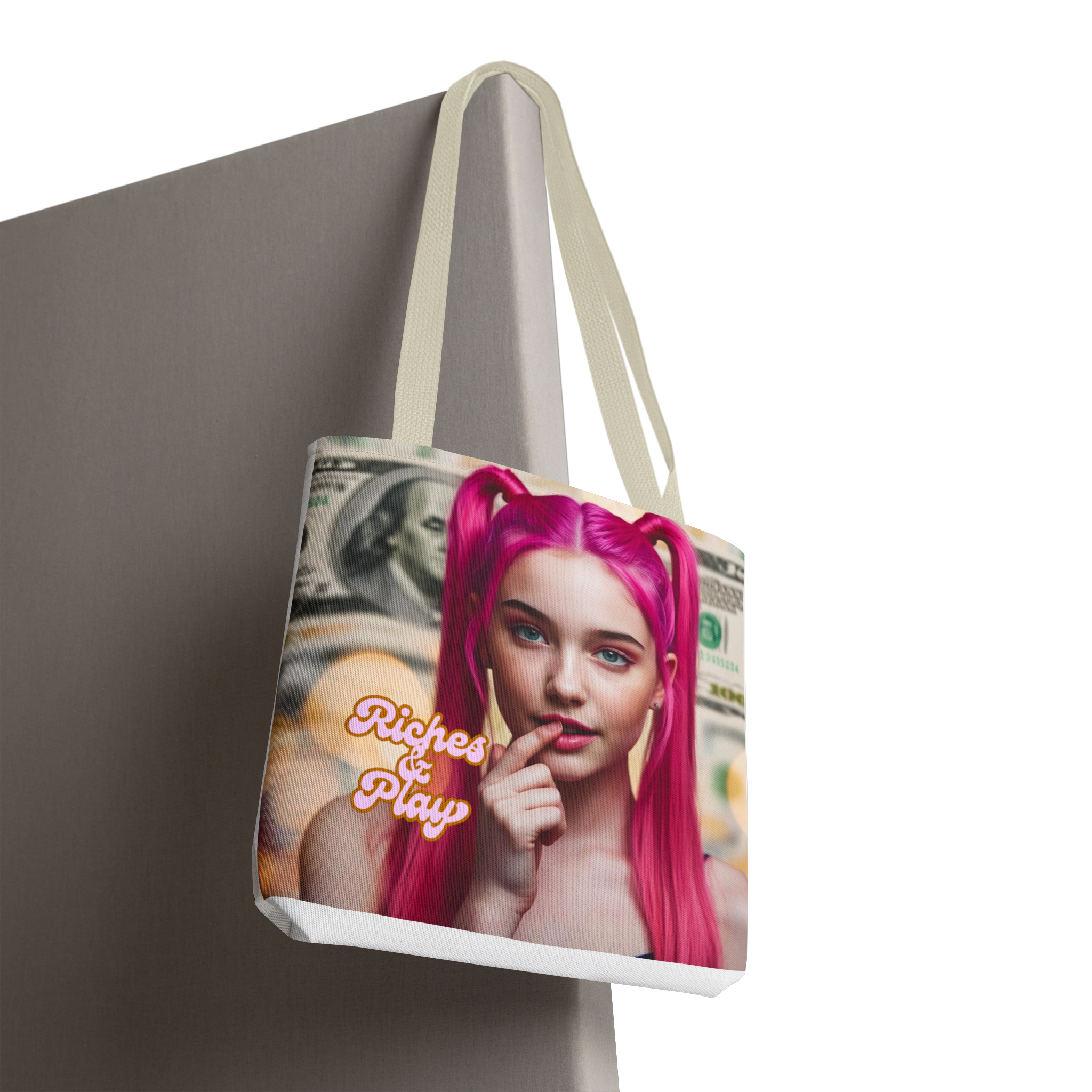 Tote bag with a graphic design of a person with pink hair and text 'Riches & Play' on a neutral background