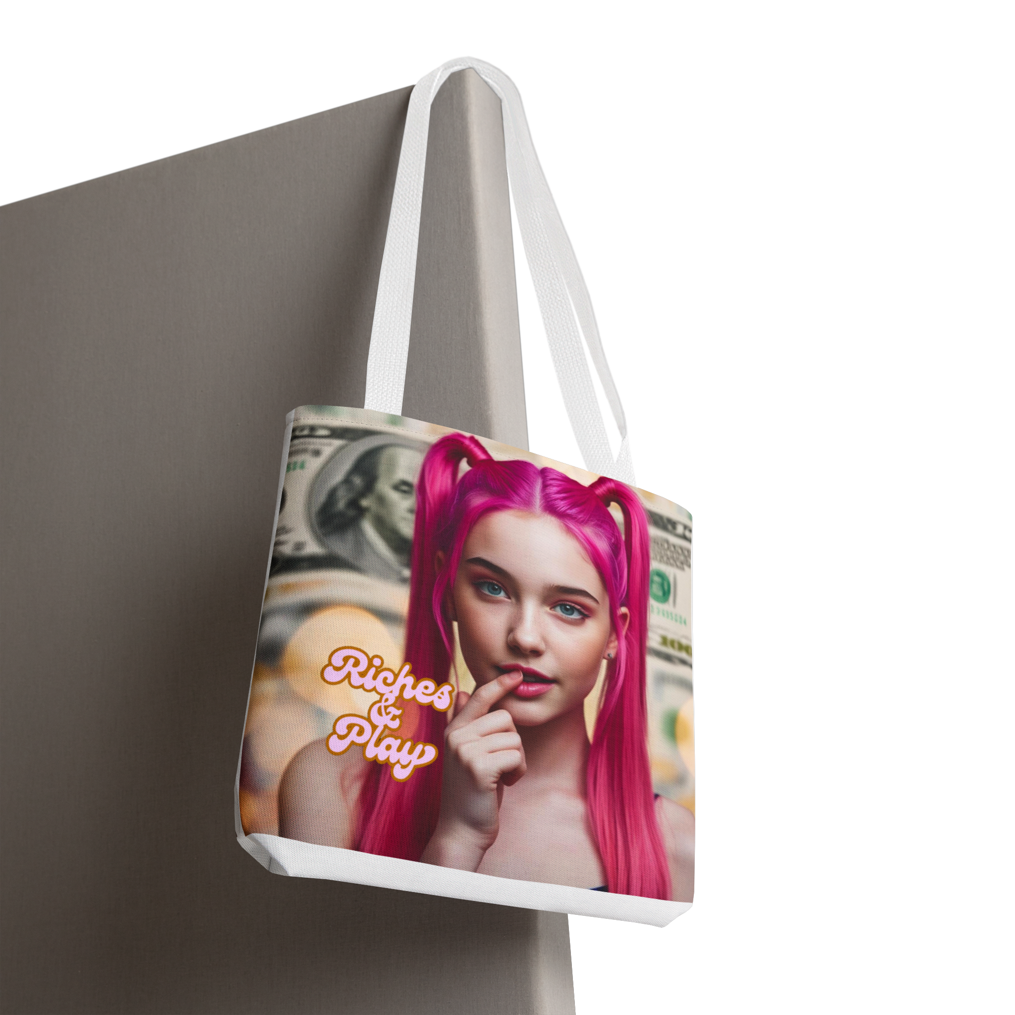 Tote bag with a graphic design of a person with pink hair and text 'Riches & Play' on a neutral background